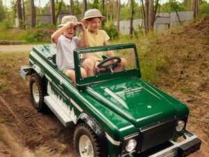 Gezinsplezier in een kinderauto Kinderauto op camping in de natuur.